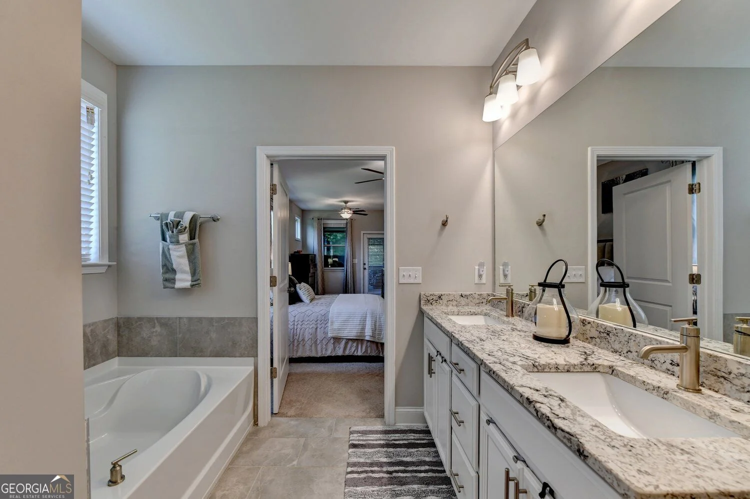 Bathroom with two vanities and a soaking tub