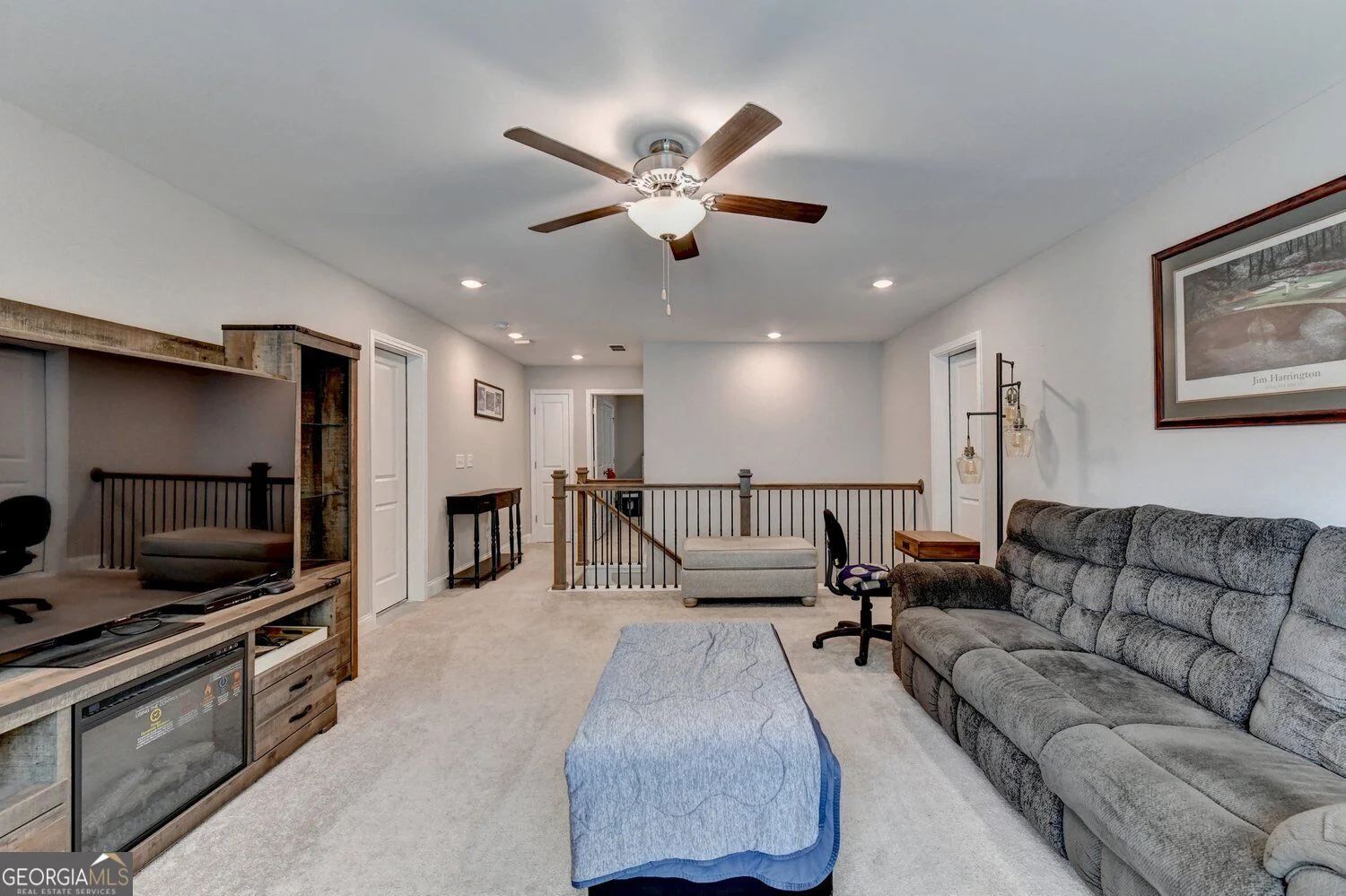 Upstairs bonus room beside the staircase railing