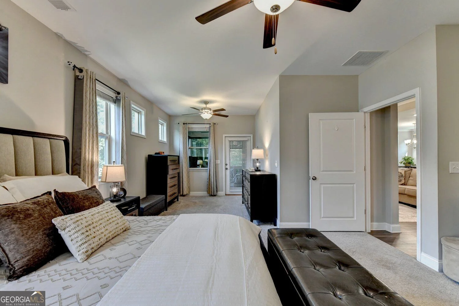 Primary bedroom with sitting area and exterior door
