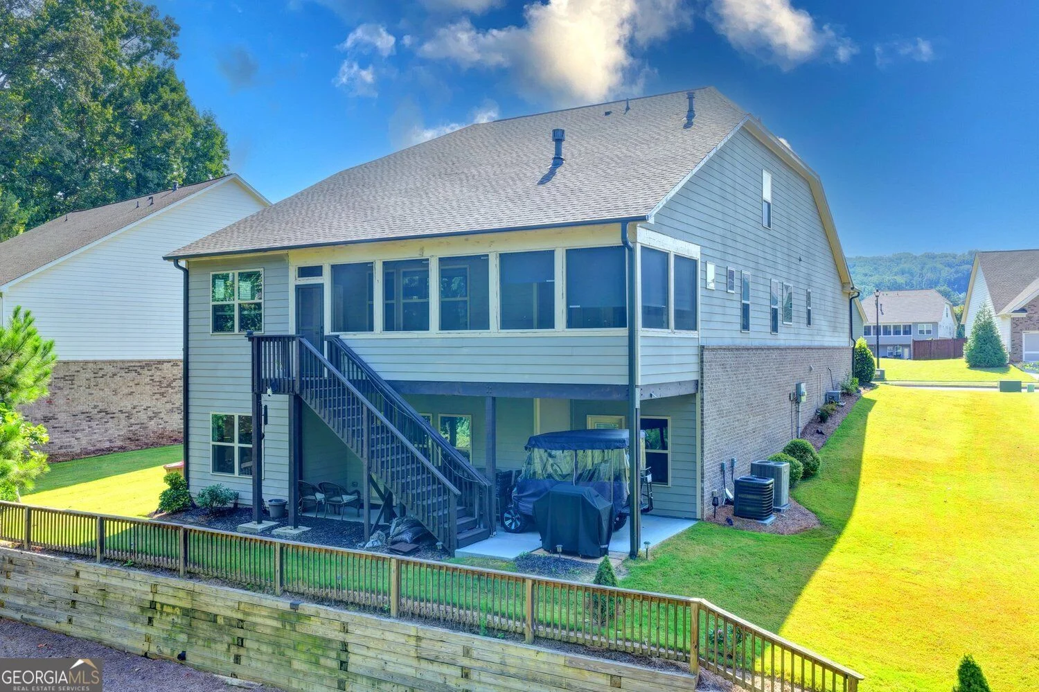Rear exterior with screened porch, stairs and lower patio